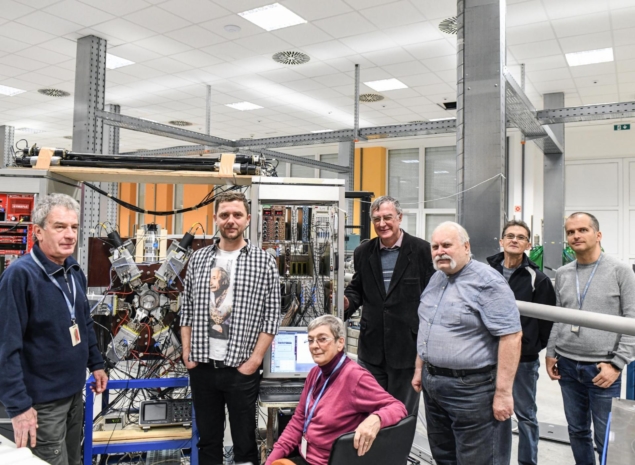 The Atomki team with the apparatus used for the latest beryllium and helium results, which detects electron-positron pairs from the de-excitation of nuclei produced by firing protons at different targets. Credit: Atomki